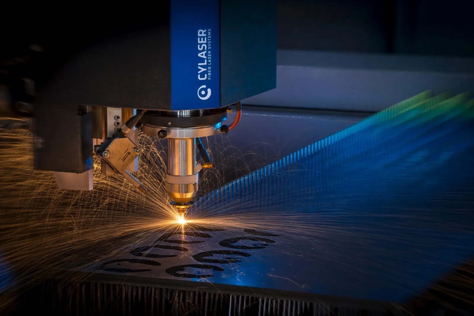 Fiber-laser head cutting steel plate in a shower of sparks