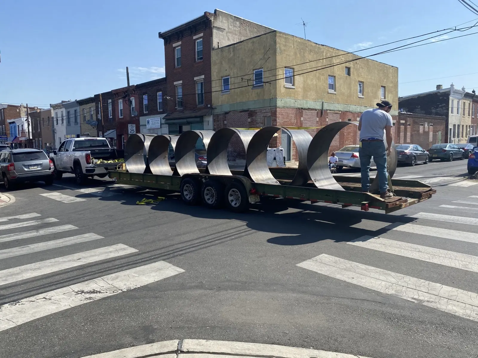 Rolled spiral parts loaded on a trailer outside the Clayton's shop